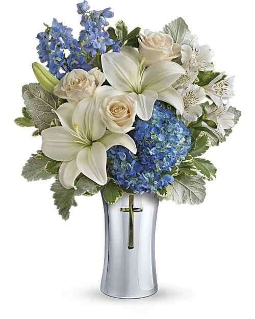 Skies of Remembrance - An elegant expression of your deepest condolences, this majestic mix of blue hydrangea and white lilies will refresh and rejuvenate their spirits. It's hand-delivered in a shining, silver-finished ceramic vase with cross cut-out - a serene, spiritual keepsake they'll always treasure.
