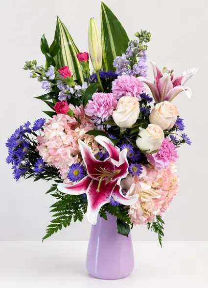 Cherished Flower Arrangement - This beautiful arrangement, filled with roses, hydrangea, lilies, fillers, and greenery, is sure to bring a smile to any mothers face this Mother's Day!