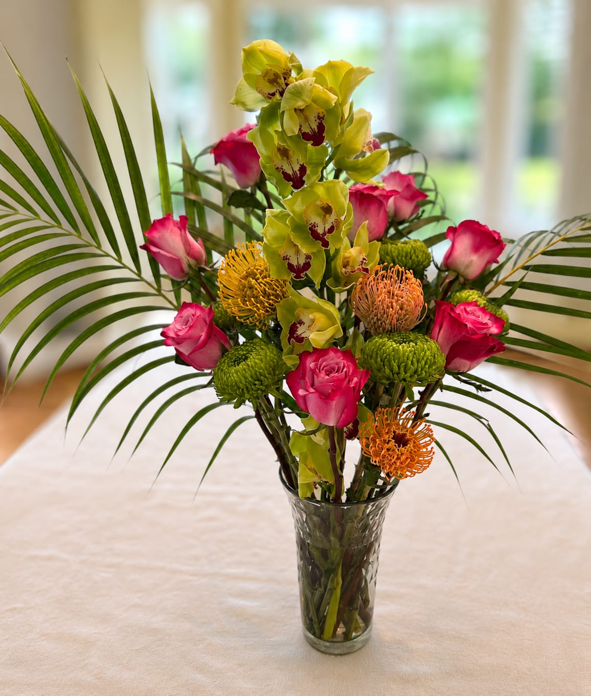 Featuring...The Cymbidium Orchid, with roses and mixed seasonal flowers - featuring a Cymbidium orchid, with roses, and seasonal flowers