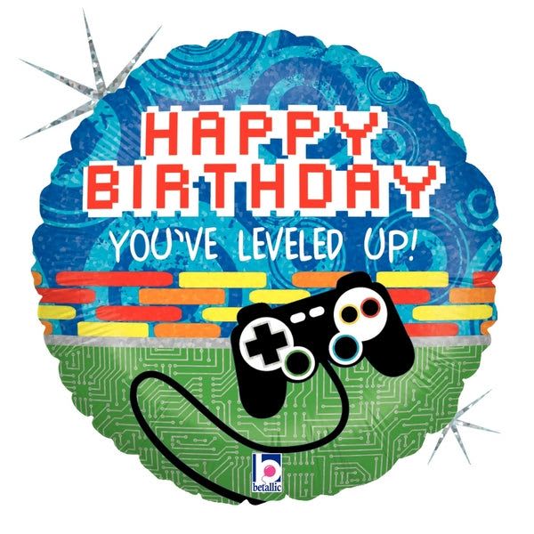 18" "You've leveled up" Happy Birthday Mylar - Celebrate a gamer's big day with a playful, video game-themed birthday arrangement centered on an 18" round foil balloon that says "HAPPY BIRTHDAY" and "YOU'VE LEVELED UP!" The bright blue upper half and vivid green lower half are accented with red and yellow highlights and tech-style graphics, so the person you're celebrating will instantly feel seen and cheered-perfect for a birthday gift or party decoration for the gamer in your life.  The foil balloon features bold block lettering and a black video game controller graphic for an unmistakable gaming vibe. Tied to a weighted base, it pairs easily with floral accents or stands alone as a colorful focal point. Lightweight and shiny, the balloon holds helium well and delivers an immediate, festive impact that reads great in photos and at door-step deliveries.