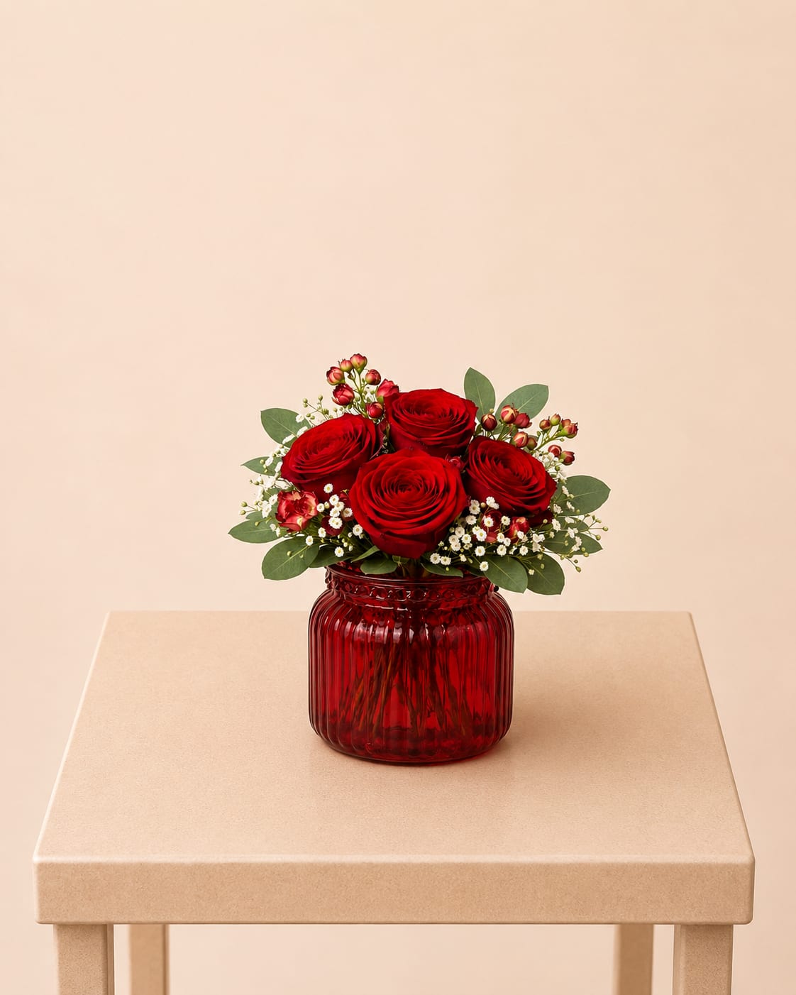 Red Romance Vase ™ - A romantic flower arrangement featuring premium red roses, accented with delicate spray roses, fresh baby’s breath, and soft eucalyptus greenery. Beautifully designed in a striking red glass vase, this piece brings warmth, love, and timeless elegance to any space.  Each arrangement is Designer’s Choice, thoughtfully created with fresh seasonal blooms. Flower varieties and color tones may vary based on availability while preserving the overall style, palette, and quality.  Perfect for Valentine’s Day, anniversaries, romantic gestures, birthdays, or adding a touch of elegance to any space or special celebration.  Same day flower delivery available in Southwest Florida, including Naples, Bonita Springs, and Fort Myers Beach.
