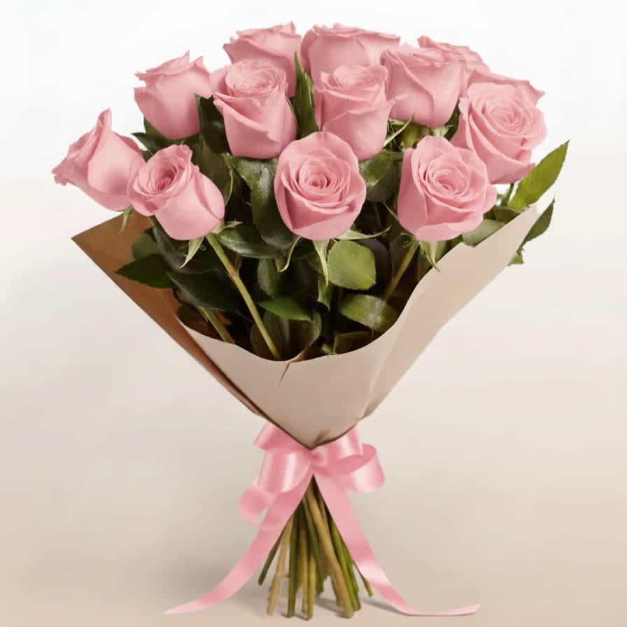 Bouquet of pink roses wrapped in brown paper with a pink ribbon