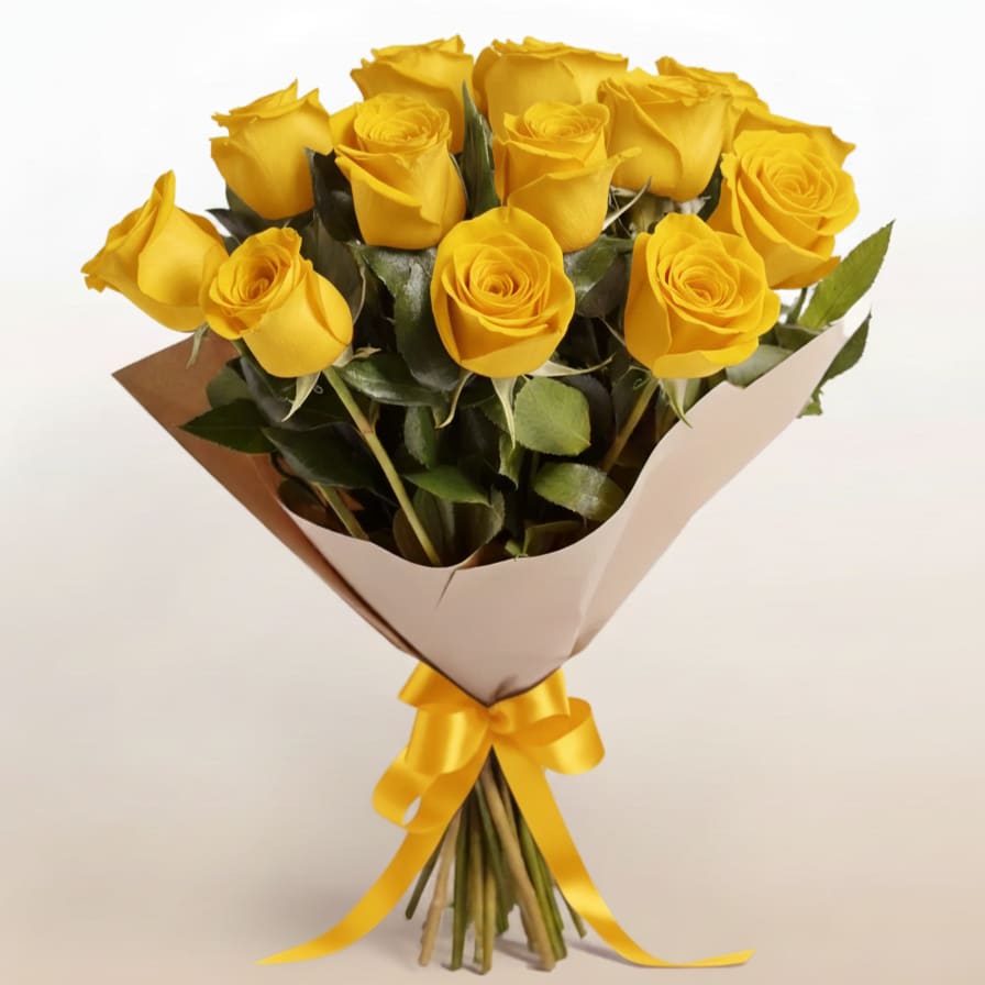 Bouquet of yellow roses wrapped in paper with a yellow ribbon