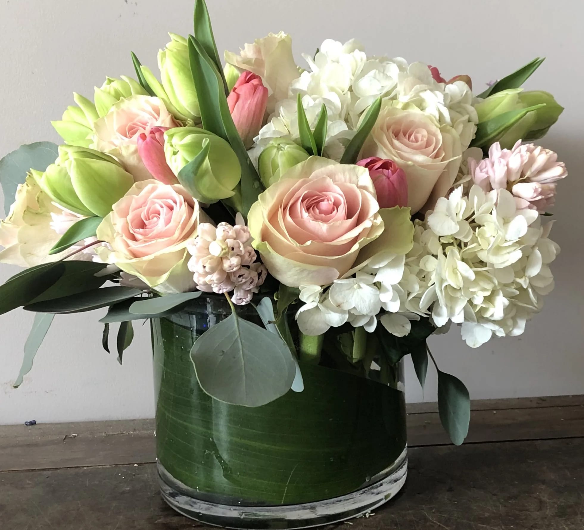 Pink roses and white hydrangeas in a glass vase