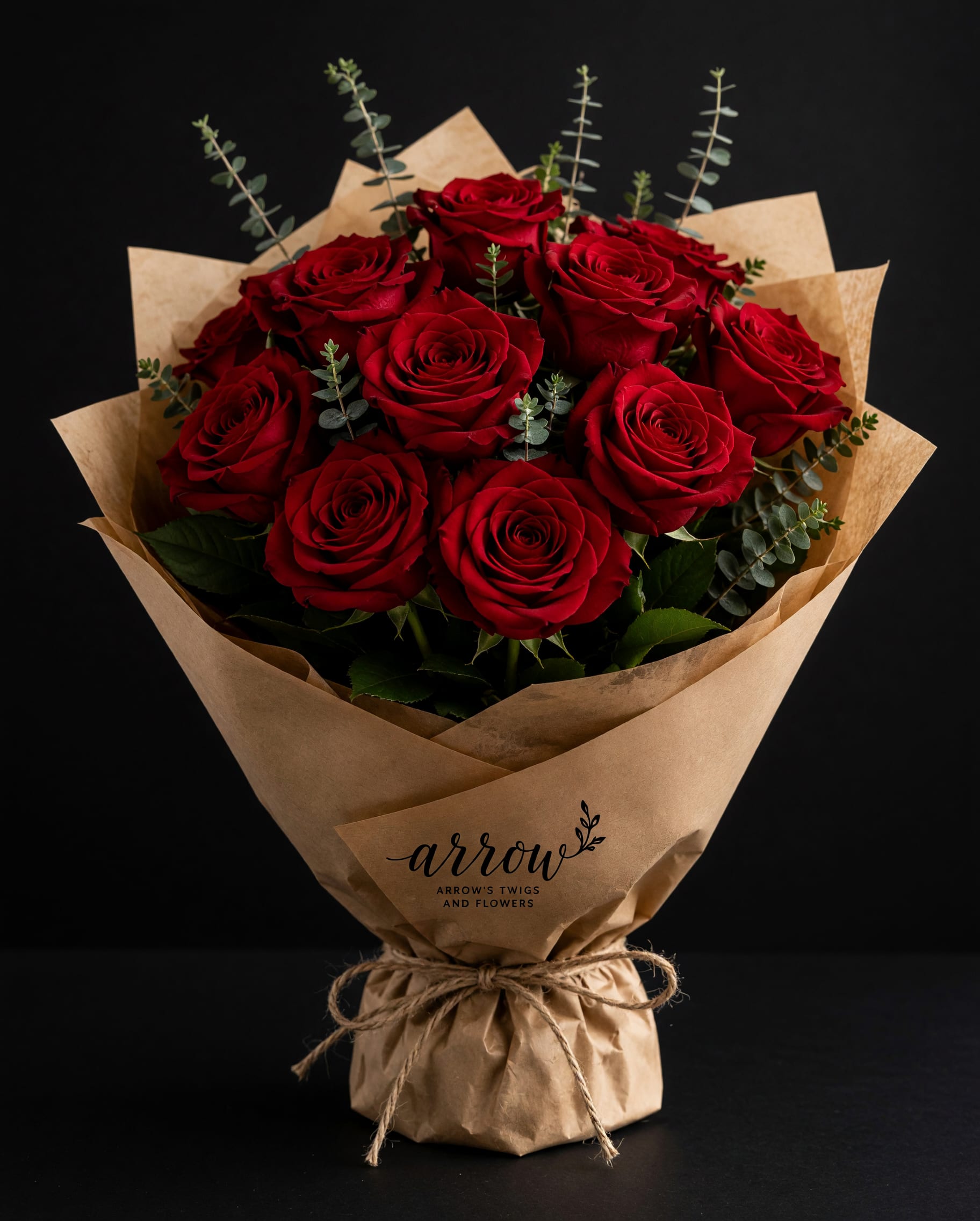 Bouquet of red roses wrapped in brown paper with twine