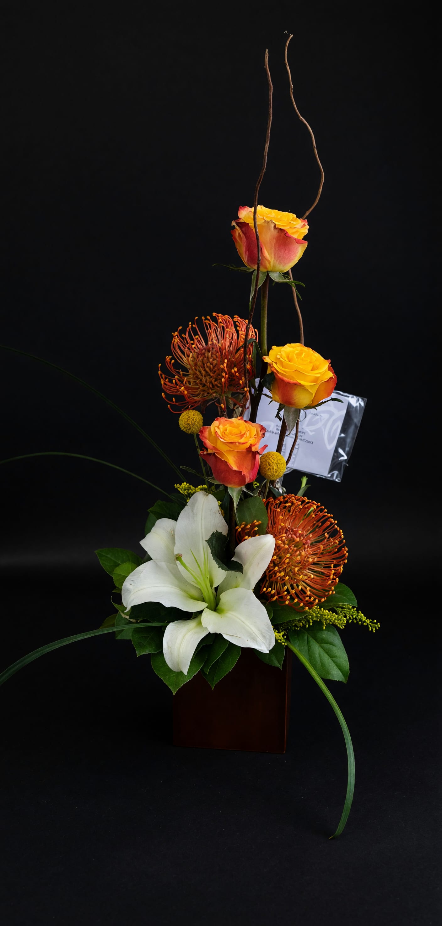 Autumn Elegance Floral Arrangement - Warm autumn blooms featuring lilies, roses, chrysanthemums, and seasonal accents in a modern design. Perfect for birthdays, thank-you gifts, fall celebrations, or adding warmth to any occasion.