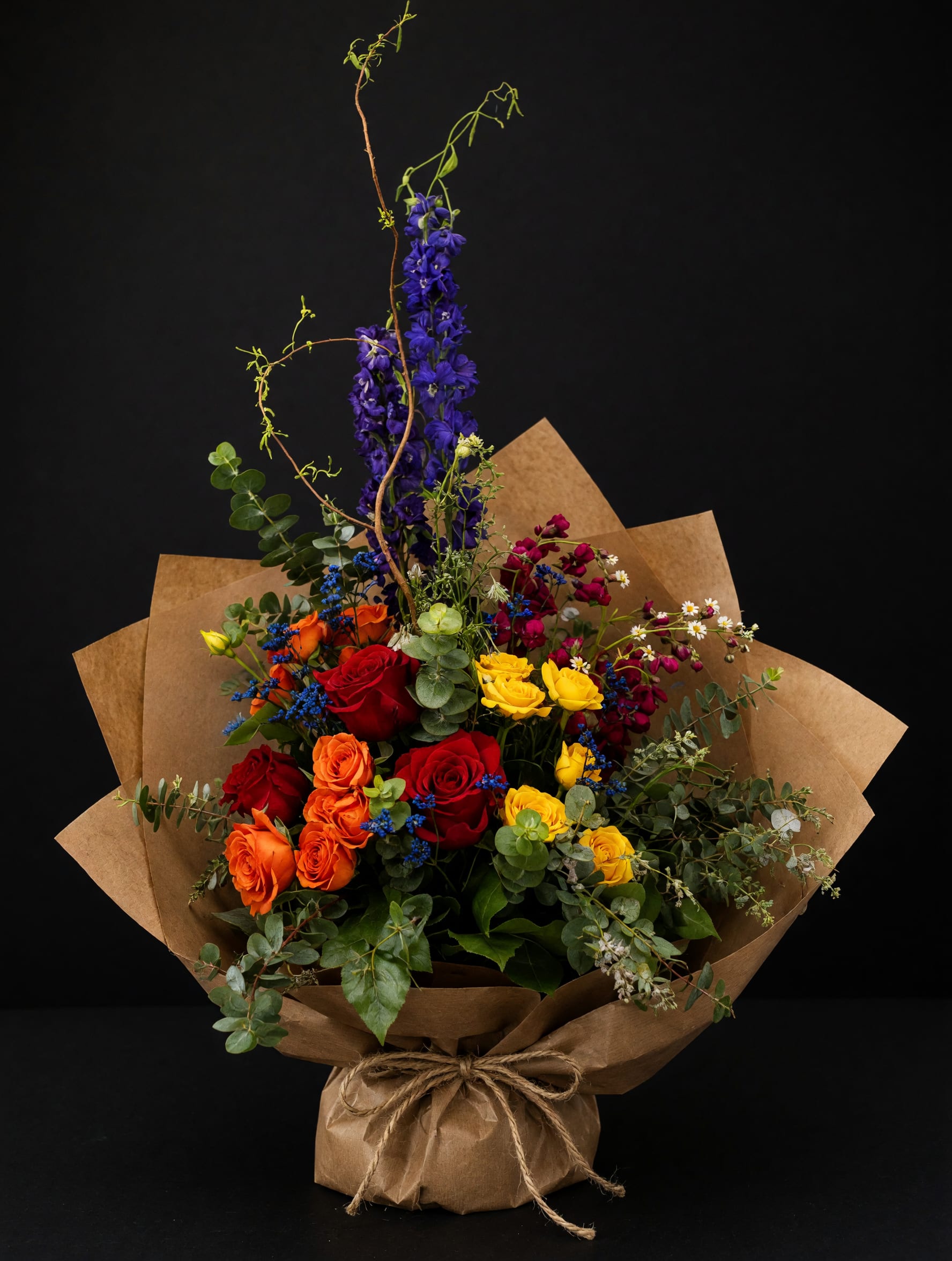 Wildflower Celebration Wrapped Bouquet - Each bouquet is handcrafted using the freshest seasonal flowers available. While flower varieties may vary, the vibrant color palette and artistic style will remain true to the original design
