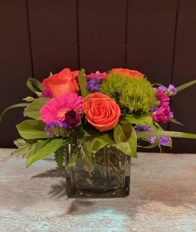 Petite &amp; Pretty - Pretty mix of fresh flowers to include; roses, gerbera daisies &amp; assorted greens. Perfect for a small space or work desk. Flowers &amp; colors may vary.