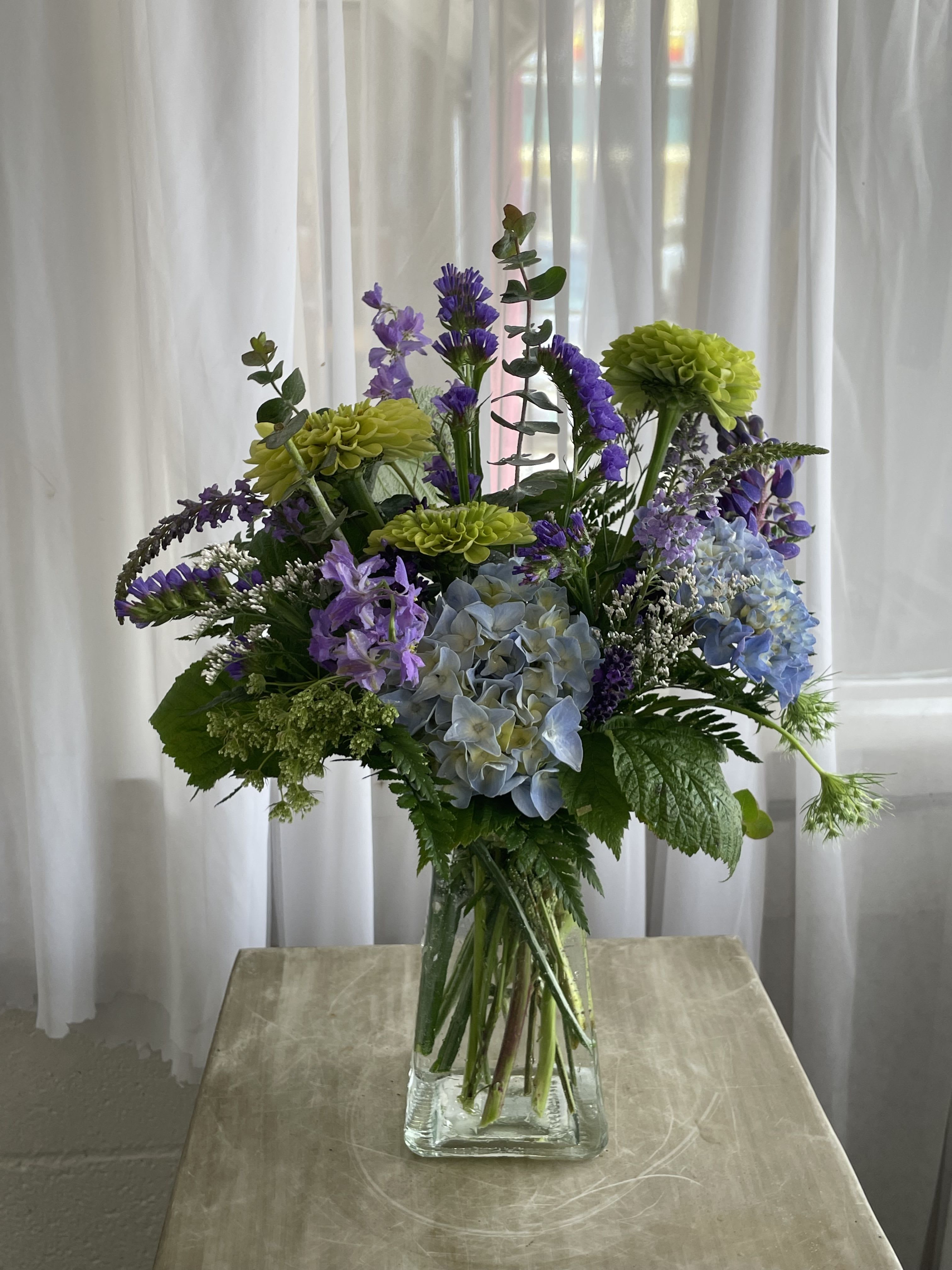 Garden by the Coast - Fathers like flowers too! Gift your dad an arrangement with greens, blues, and purples. 