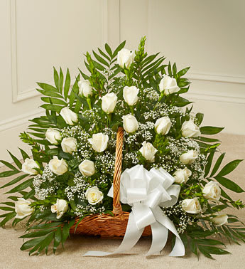 Basket of white roses with baby's breath and a white ribbon bow