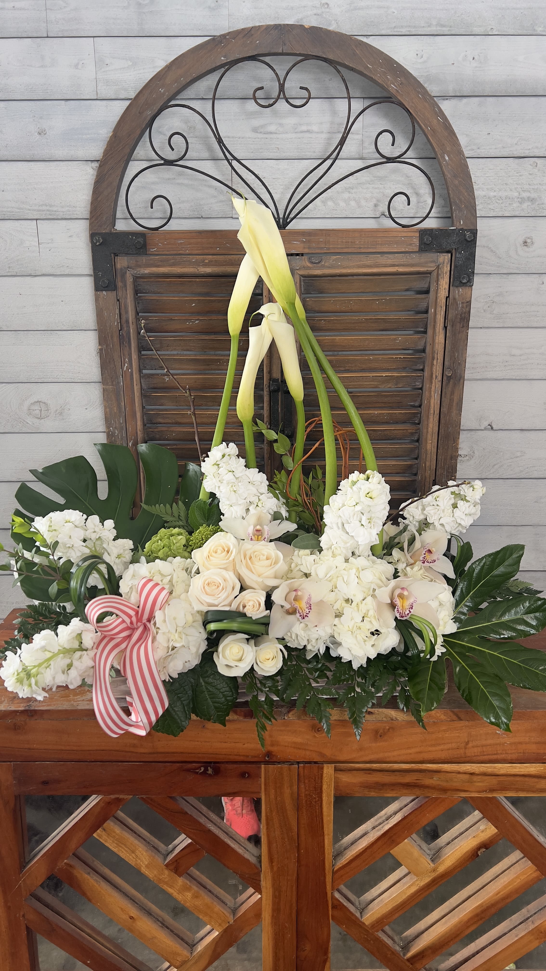 Be The Good  - Long and shot vase with tropical leaves and premium calla lilies 