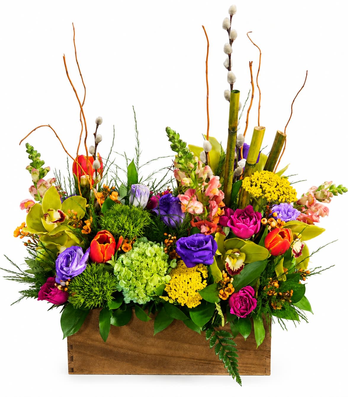 Colorful mixed flower arrangement in a wooden box with tall branches