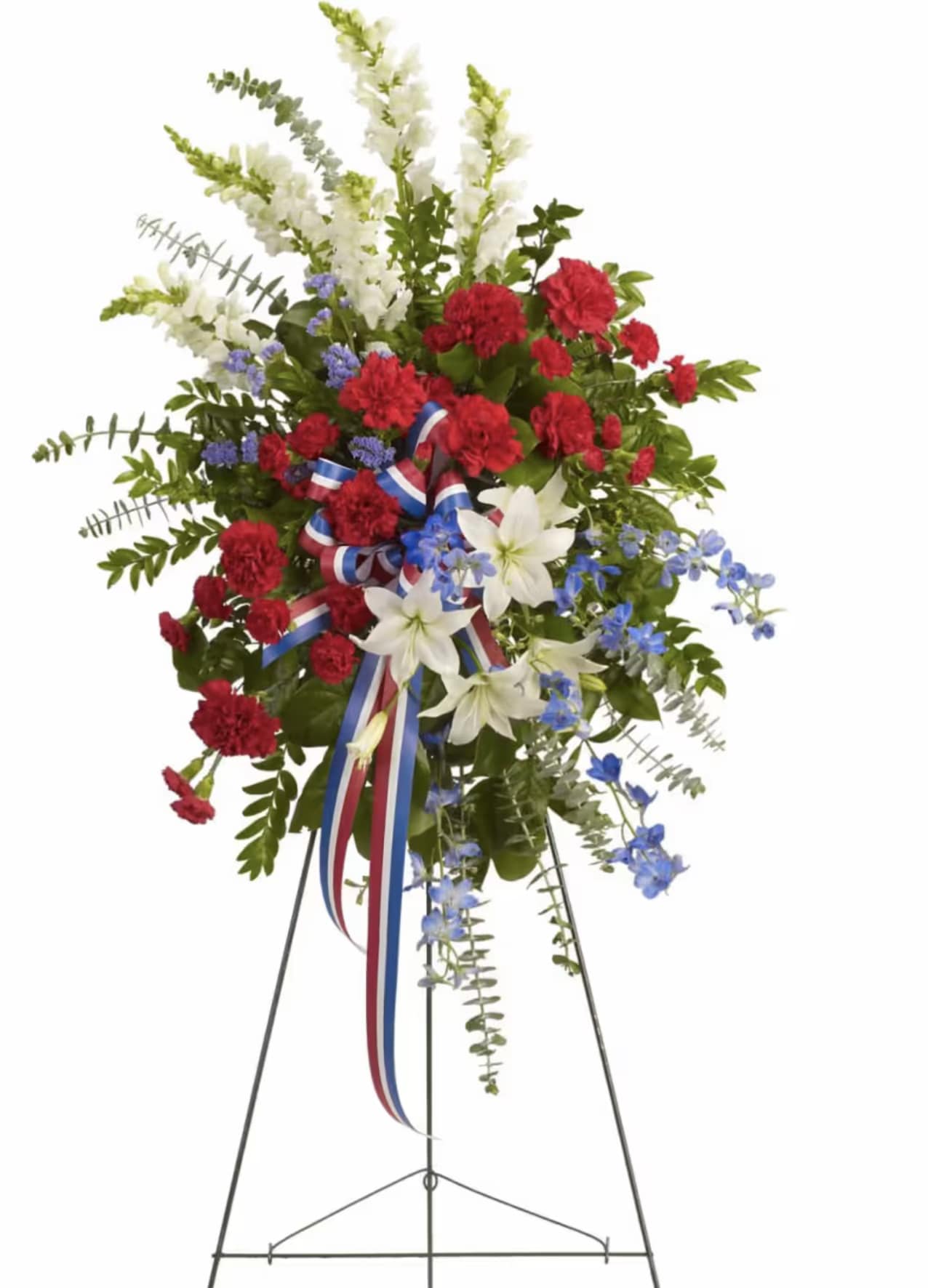 Standing floral spray with red, white, and blue flowers on a metal easel