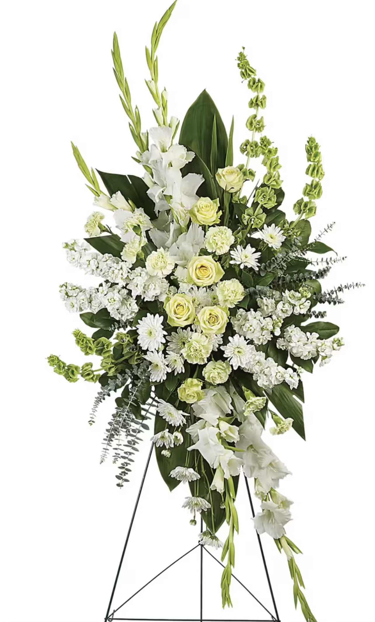 White and pale yellow funeral spray on a black easel