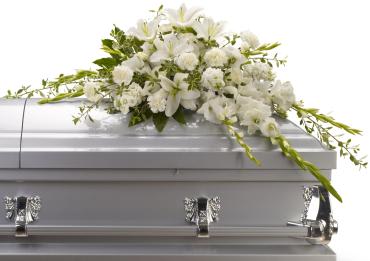 White floral spray on a silver casket