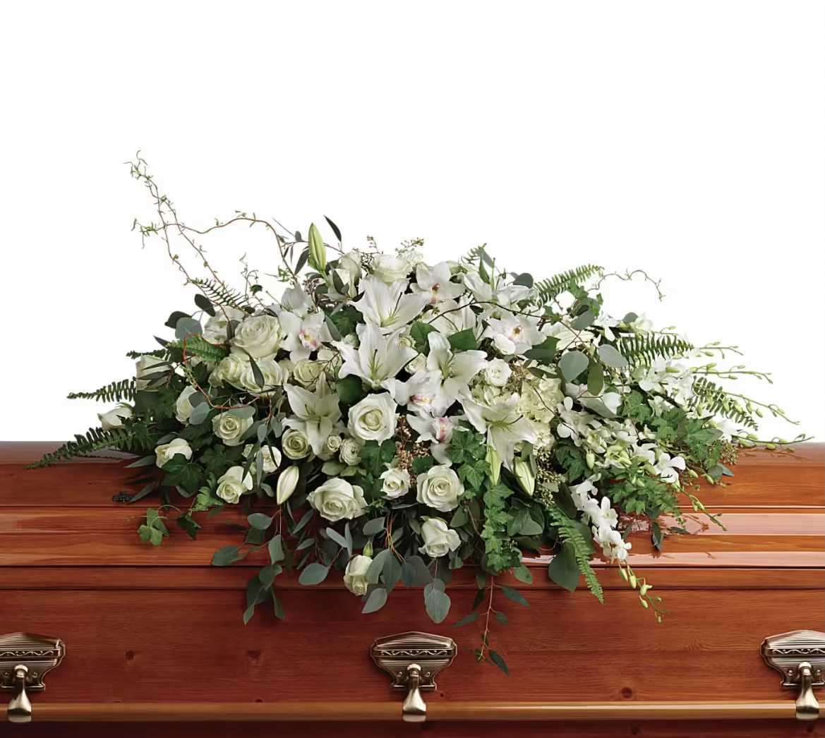 White floral casket spray with roses and lilies