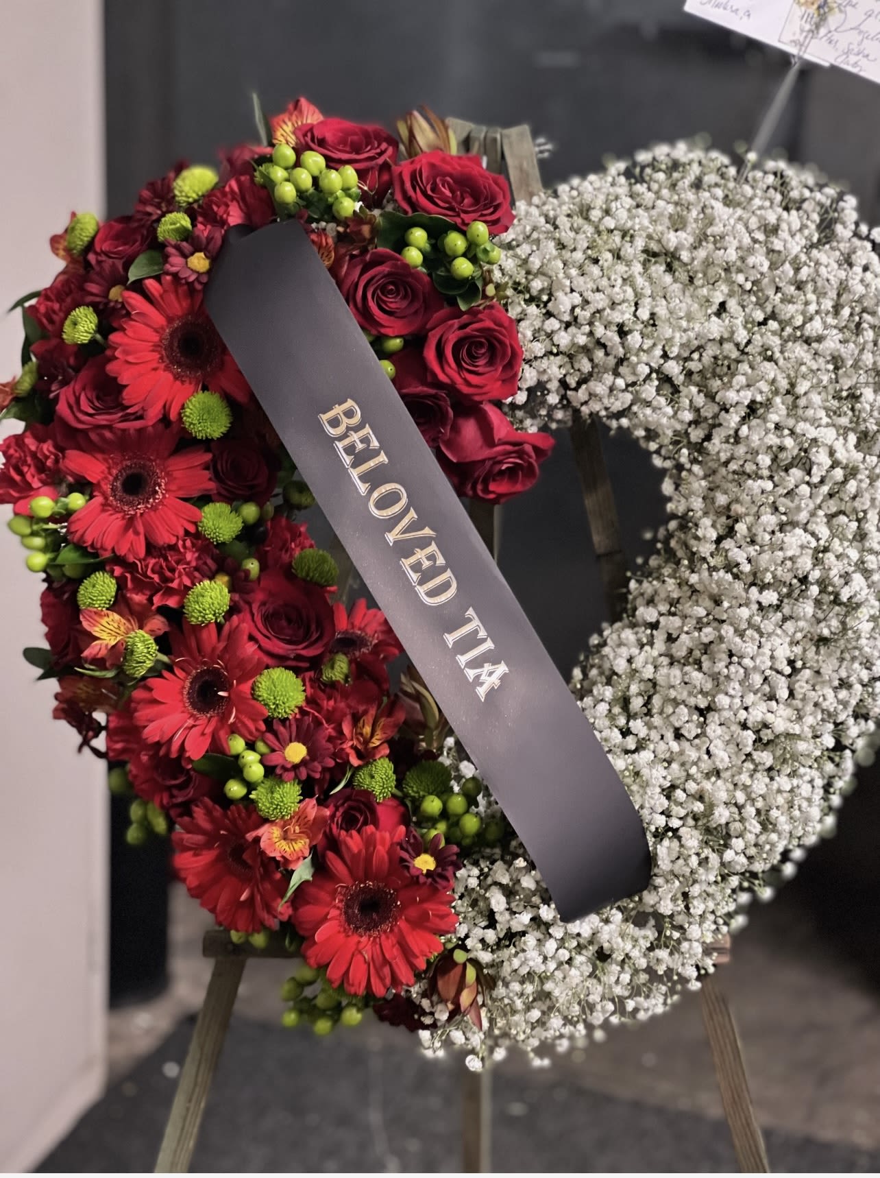 Heart-shaped floral wreath with red roses and white baby's breath