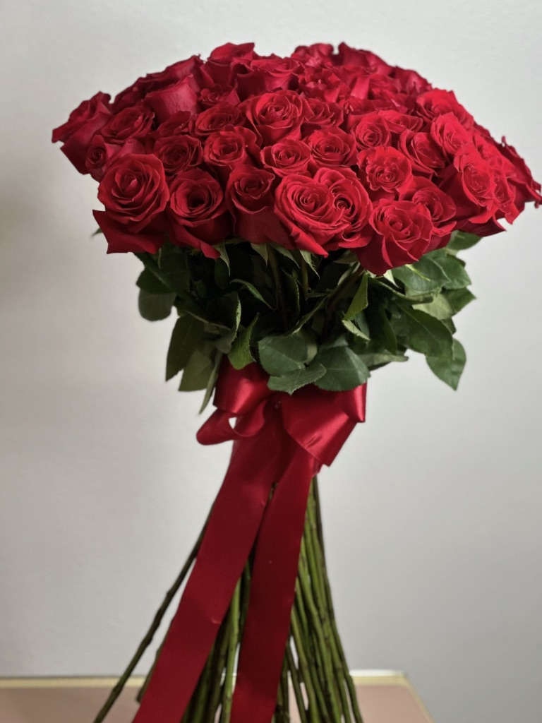 Bouquet of red roses tied with a red satin ribbon
