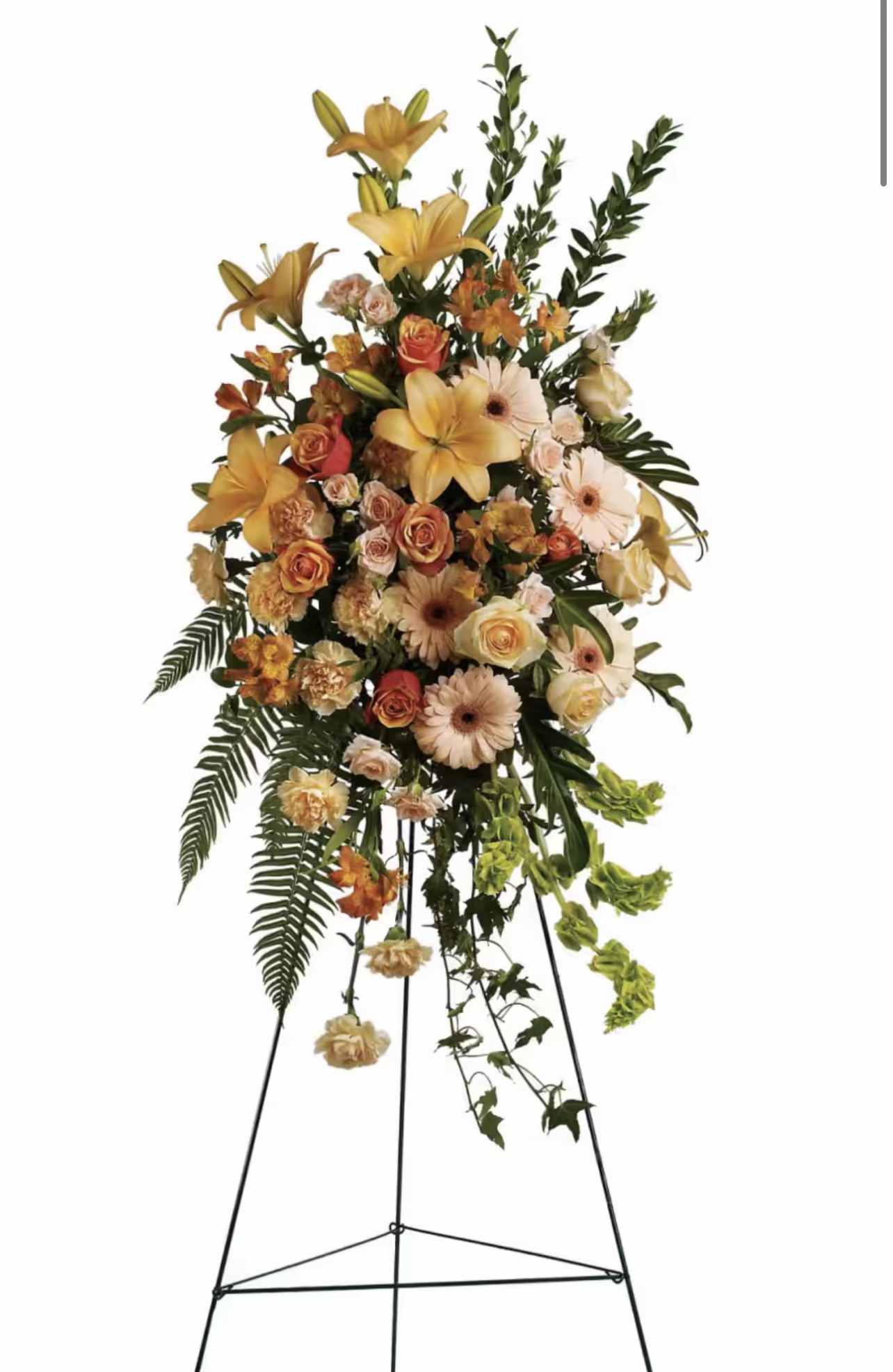 Tall floral standing spray with yellow lilies, peach roses, and pale gerbera daisies