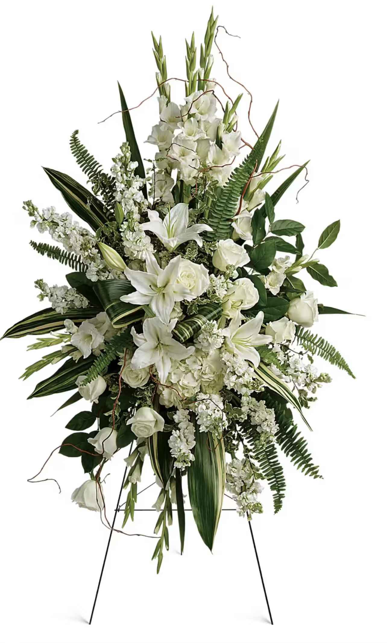White floral standing spray with lilies and roses on a black easel