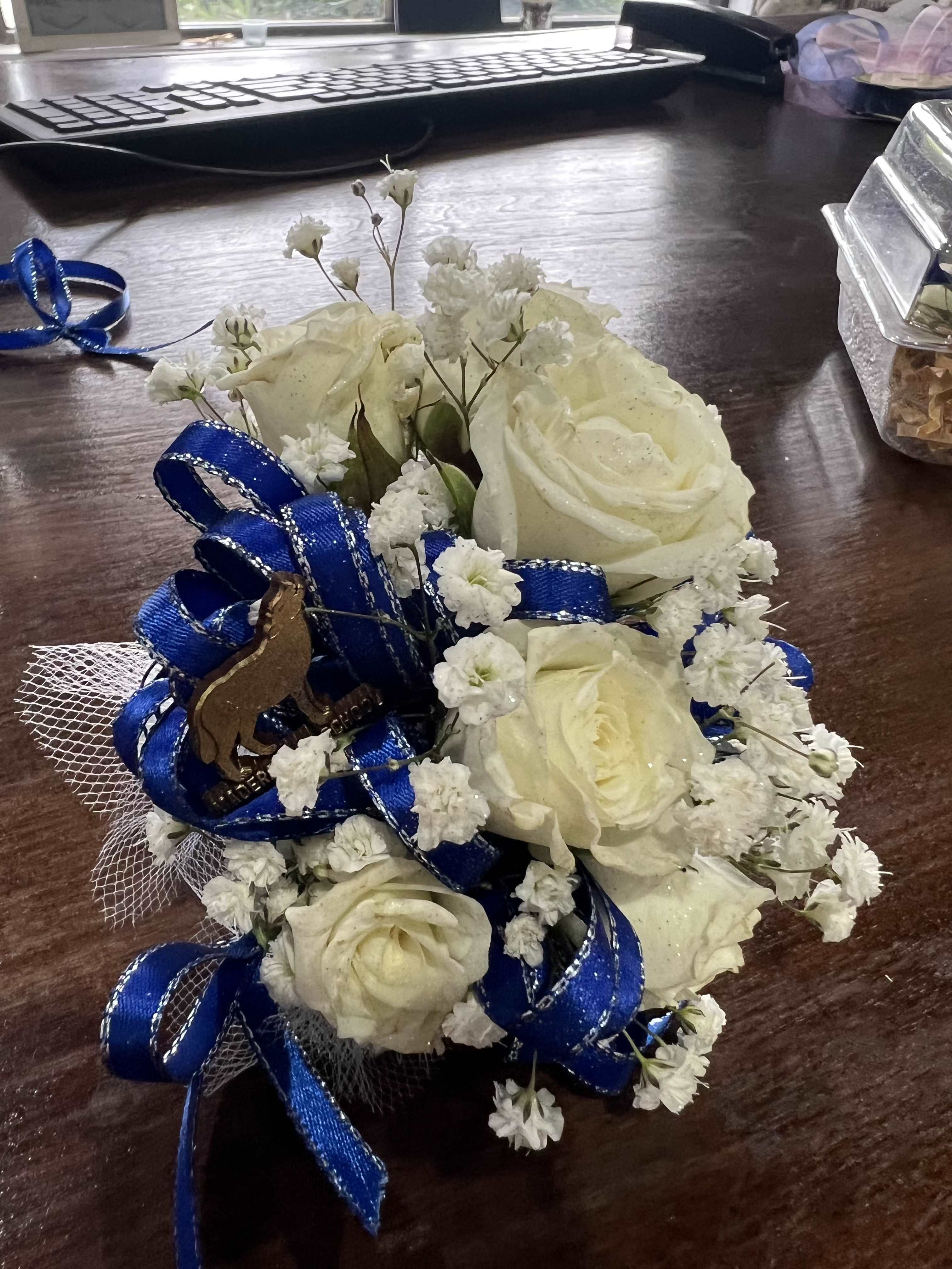 Small bouquet of white roses with blue ribbon and baby's breath