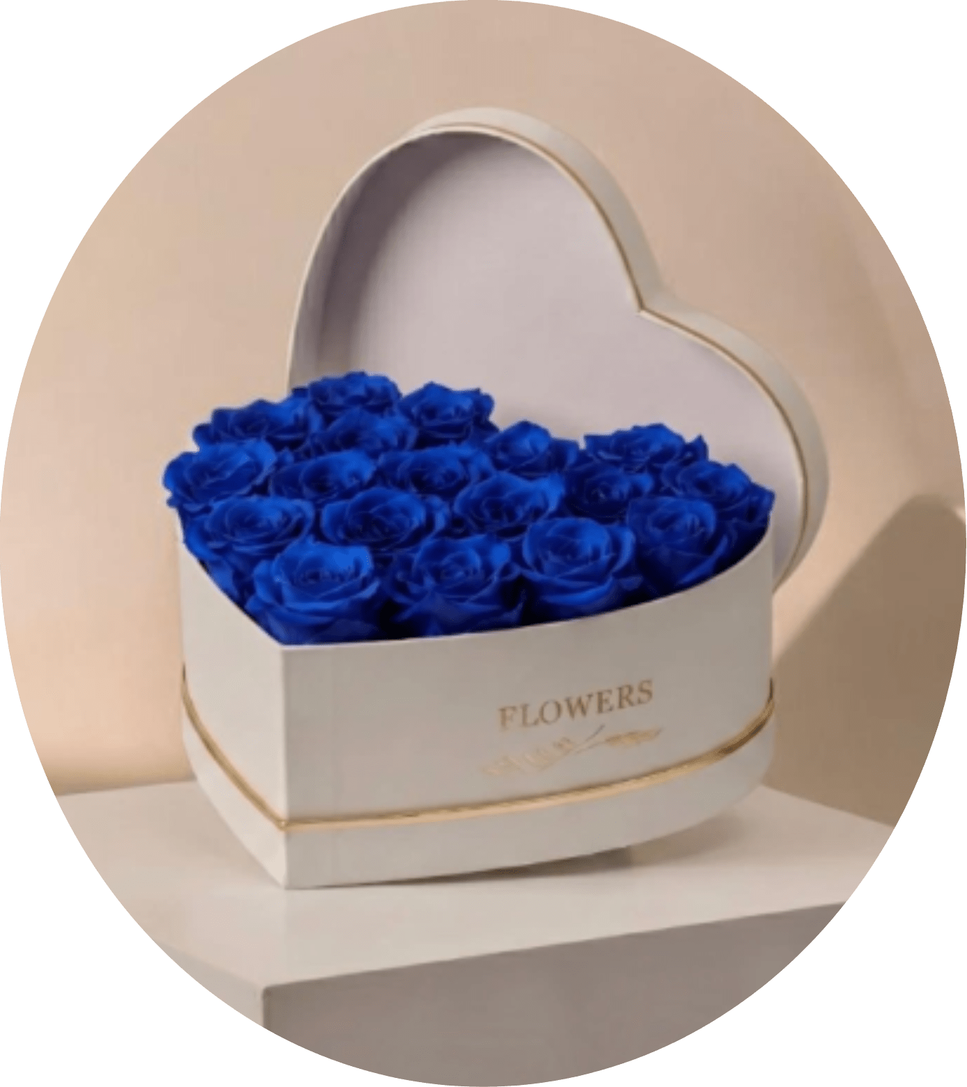 BLUE KING - A striking heart-shaped box filled with densely packed vivid blue roses creates an unforgettable romantic gift for an anniversary or love-themed occasion. The saturated cobalt blooms form a bold, monochromatic mass that reads as modern and dramatic; set in a white heart presentation box with a thin gold trim and a matching lid propped behind, this arrangement feels polished and luxurious-the kind of gift that makes the person you're thinking of feel truly adored and noticed.  Compact and tabletop-sized, the design is symmetrical and tightly arranged for maximum visual impact. The white box softens the intensity of the blue roses while the gold detailing adds an elegant, gift-box finish-perfect for presenting on a mantel, bedside table, or at a special dinner. Order this as a romantic statement piece to mark anniversaries, proposals, or any moment you want to make feel celebratory and deeply personal.