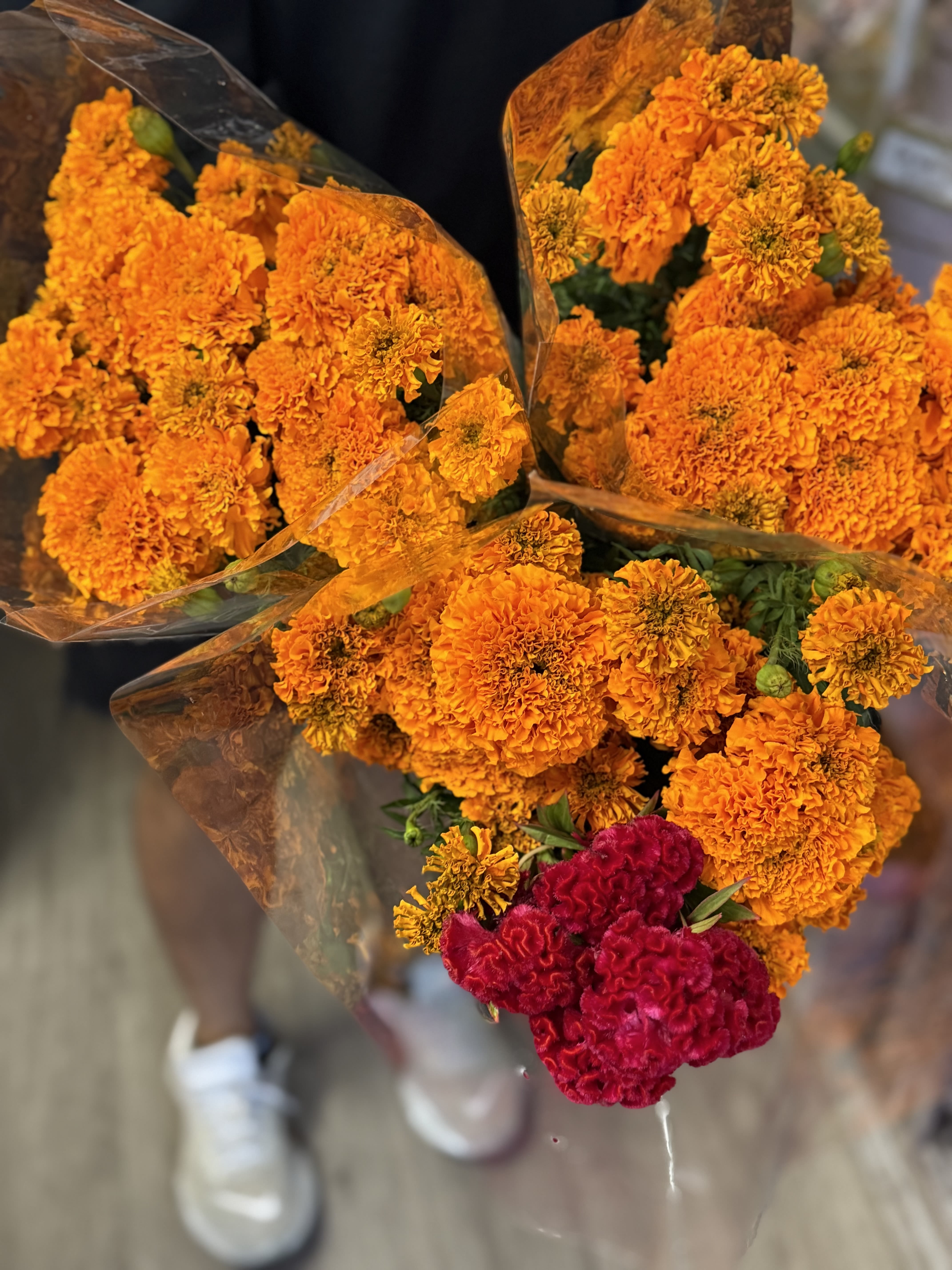 Bouquets of orange marigolds with a cluster of red cockscomb flowers