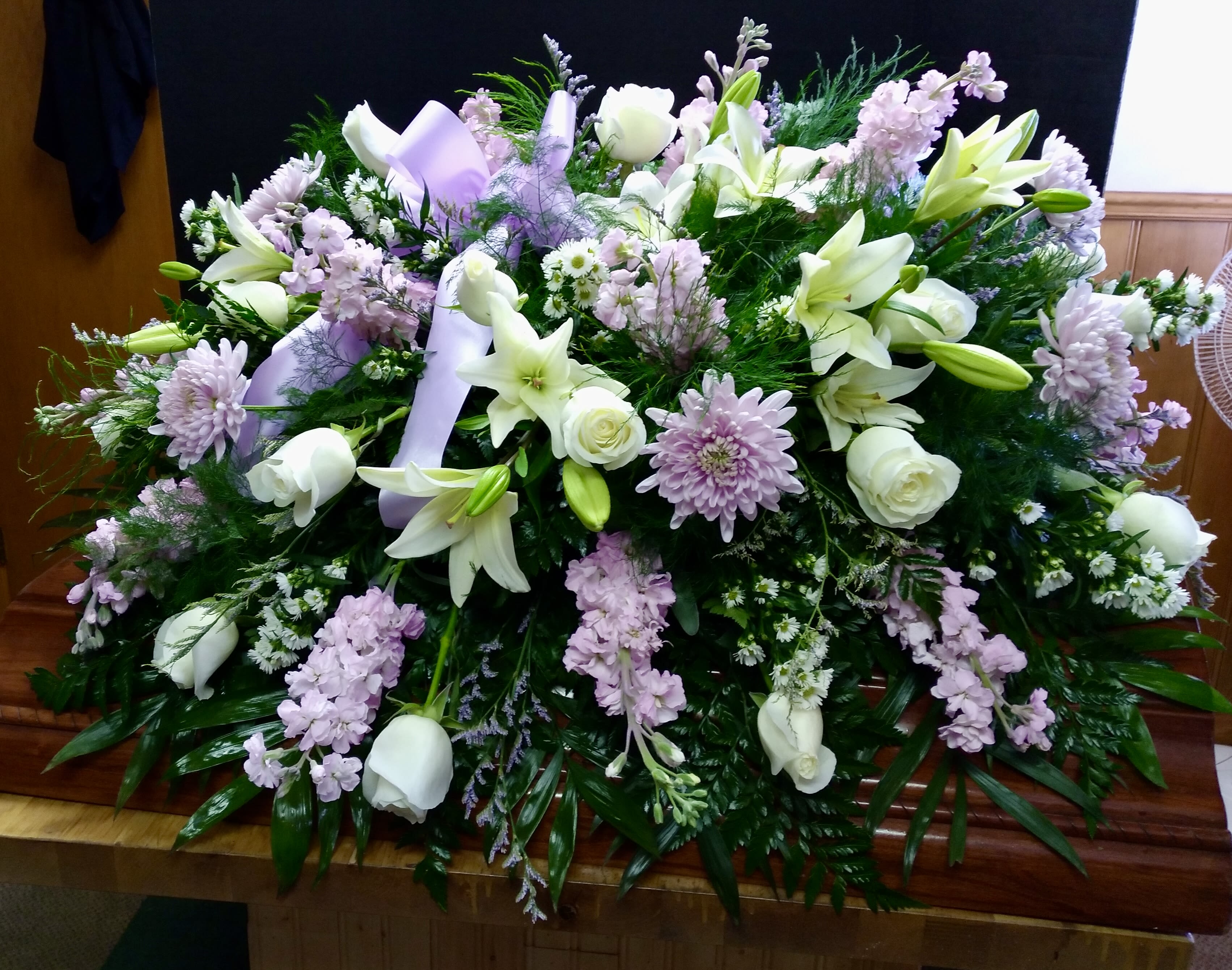 Lavender &amp; White Casket Spray - A beautiful lavender and white Casket Spray, featuring lovely blooms of Lilies, Roses, Stock and more.  