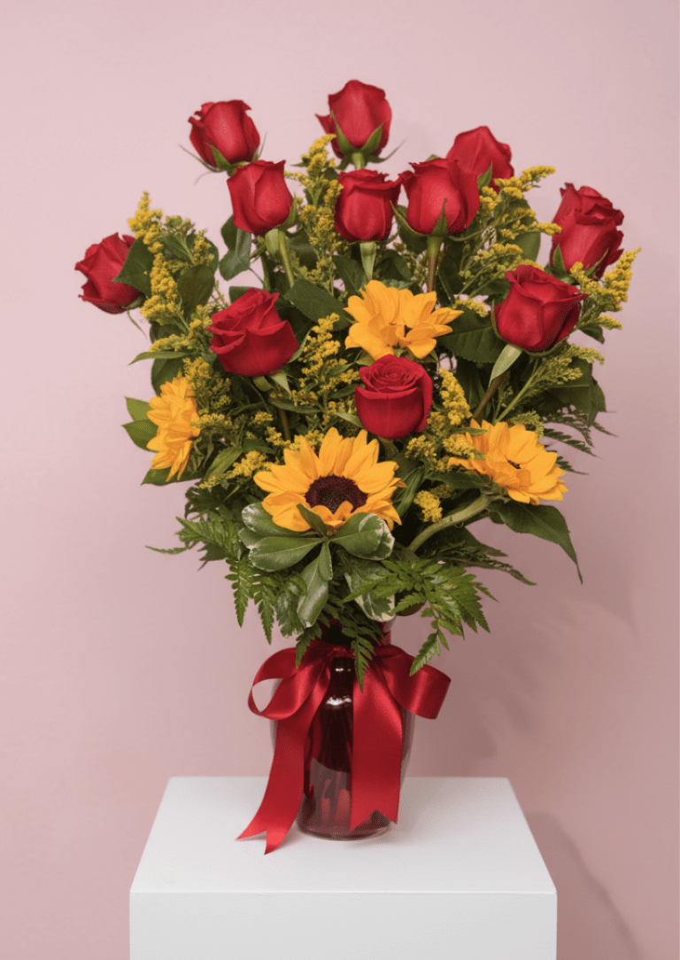 Sunlit Romance  - A bold red-and-gold contrast greets the recipient with clustered red roses set above sunny yellow sunflowers-an eye-catching flower arrangement perfect for an anniversary, birthday, or a heartfelt congratulations.   Send this arrangement as a bright everyday gift, a thank-you gesture, or a romantic surprise-she'll feel genuinely celebrated when it arrives. Vase-ready and trimmed for immediate display; swap water and recut stems every few days to keep blooms fresh longer.
