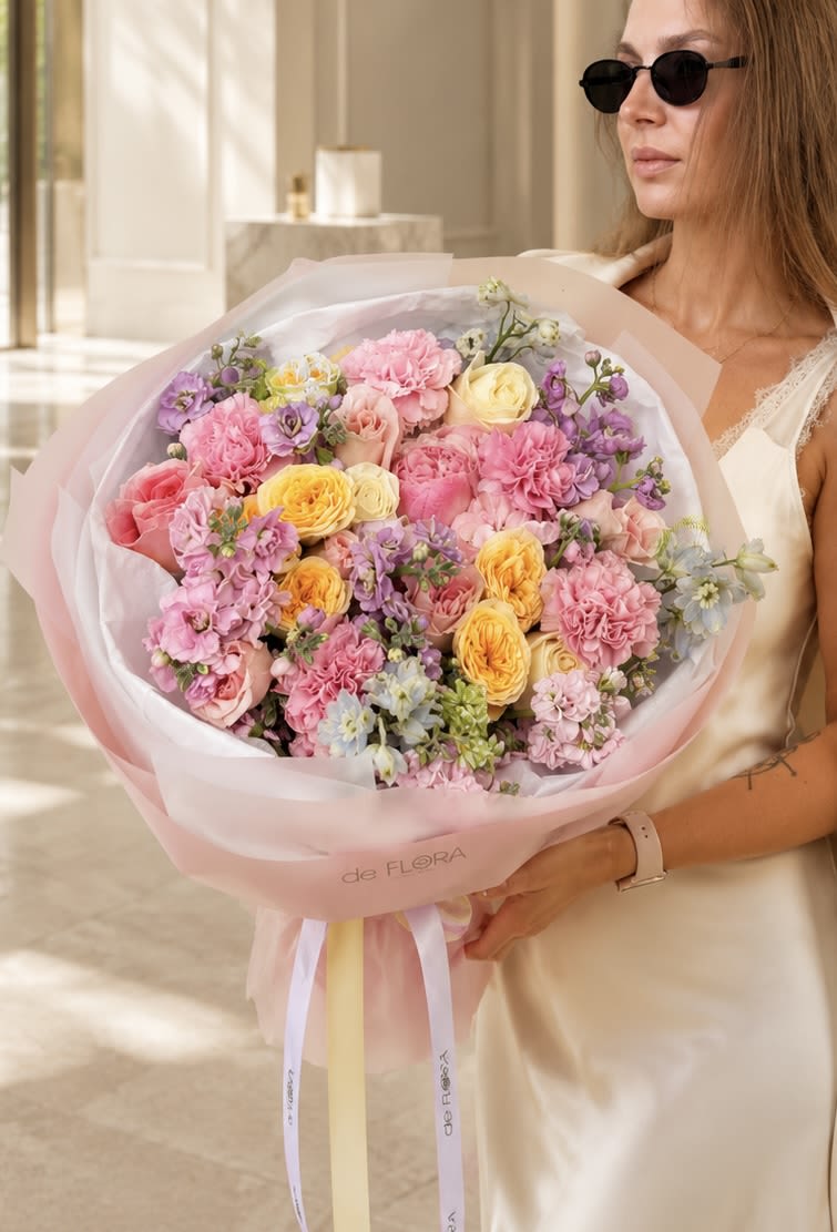 Blush Sonata - Blush Sonata is a luxurious garden-style bouquet handcrafted with premium peonies, garden roses, roses, carnations, stock, and seasonal blooms in a harmonious palette of blush pink, buttery yellow, ivory, and soft lavender. Wrapped in deFLORA’s signature luxury packaging, this elegant arrangement captures the beauty of a blooming European garden and makes an unforgettable gift for birthdays, anniversaries, celebrations, or simply to brighten someone’s day. Every bouquet is thoughtfully designed to embody effortless sophistication, romance, and timeless beauty. 