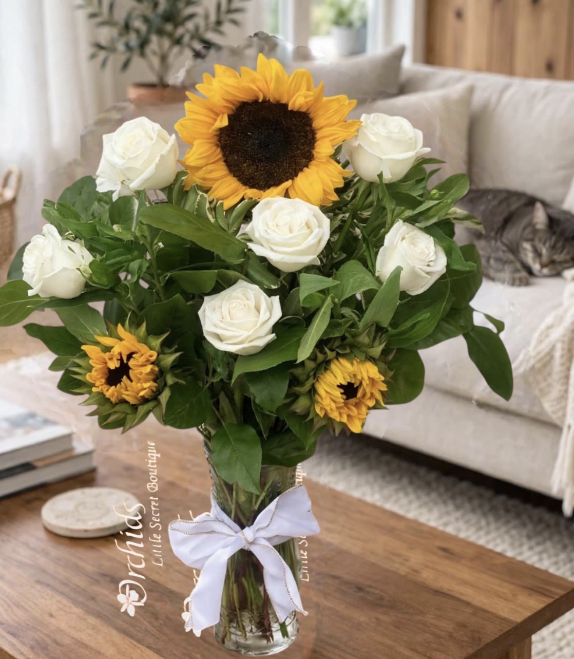 Sunflower White Roses Bouquet | Cat Lover's Collection - Brighten someone's day with our elegant Cat Lover's Sunflower &amp; Rose Bouquet, thoughtfully designed with flowers that are generally considered non-toxic to cats. Featuring radiant sunflowers paired with premium roses, this handcrafted bouquet combines cheerful beauty with timeless elegance, making it a wonderful choice for pet-conscious homes.  Whether you're celebrating a birthday, expressing gratitude, welcoming someone home, or simply sending a thoughtful surprise, this bouquet is designed to create lasting smiles.  Please Note: While the flowers in this bouquet are generally considered non-toxic to cats, we recommend keeping all flowers out of reach of pets, as chewing on any plant material may cause mild digestive upset.