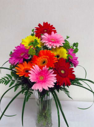 Colorful gerbera daisy bouquet in a clear glass vase