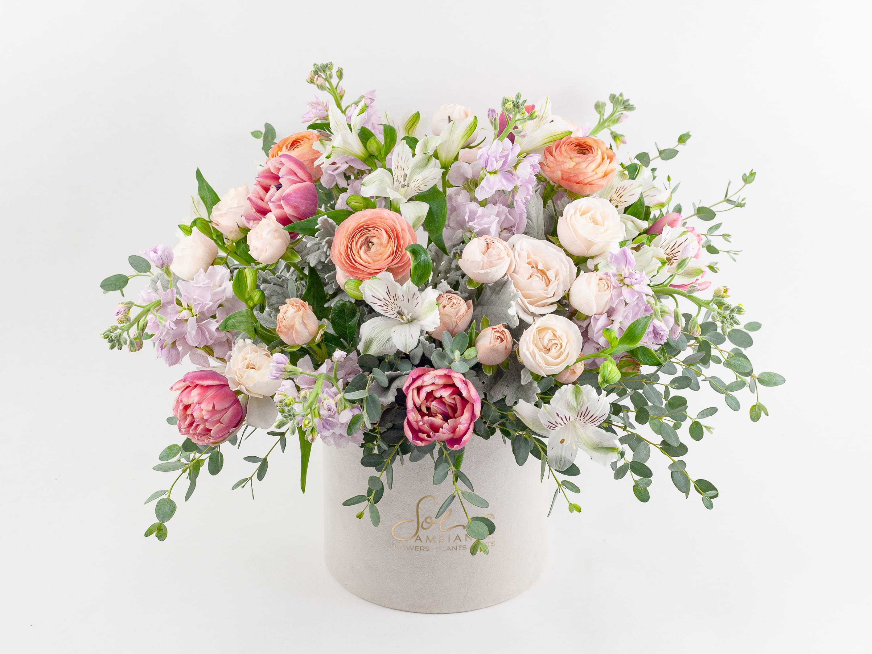 Mixed pastel bouquet in a white hatbox-style container