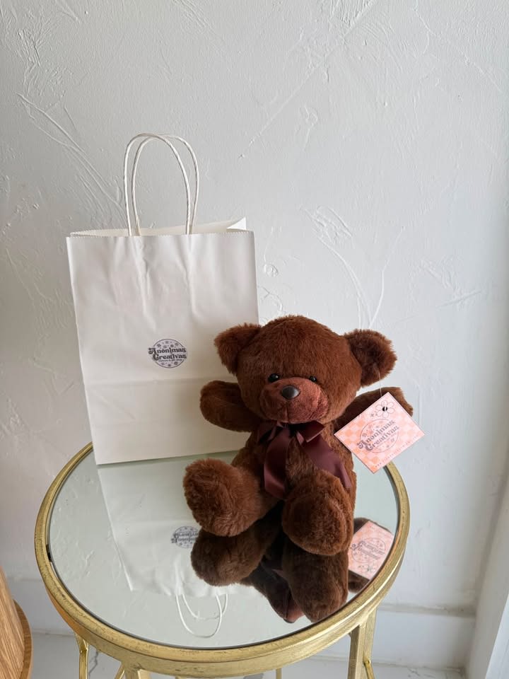 Chocolate Brown Plush Teddy Bear - Make your gift even more memorable with our Chocolate Brown Plush Teddy Bear, a soft and cuddly keepsake that brings warmth, love, and comfort. Crafted with premium plush fabric and finished with a beautiful satin ribbon, this adorable teddy bear is the perfect companion for any special occasion.  Whether paired with flowers, balloons, chocolates, or a gift basket, this timeless teddy bear adds a heartfelt touch that will be cherished for years to come. Perfect For:  * Birthdays * Anniversaries * Valentine’s Day * Get Well Soon Gifts * New Baby Celebrations * Sympathy &amp; Comfort Gifts * Just Because  Features:  * Ultra-soft premium plush material * Elegant satin ribbon bow * Classic chocolate brown color * Perfect gift add-on for floral arrangements and gift baskets * Suitable for children and adults 