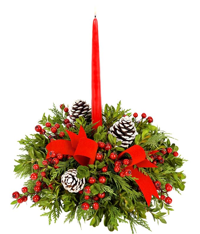 Red taper candle in a holiday greenery arrangement with pinecones and berries