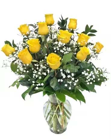 Yellow roses arranged in a clear glass vase with baby's breath