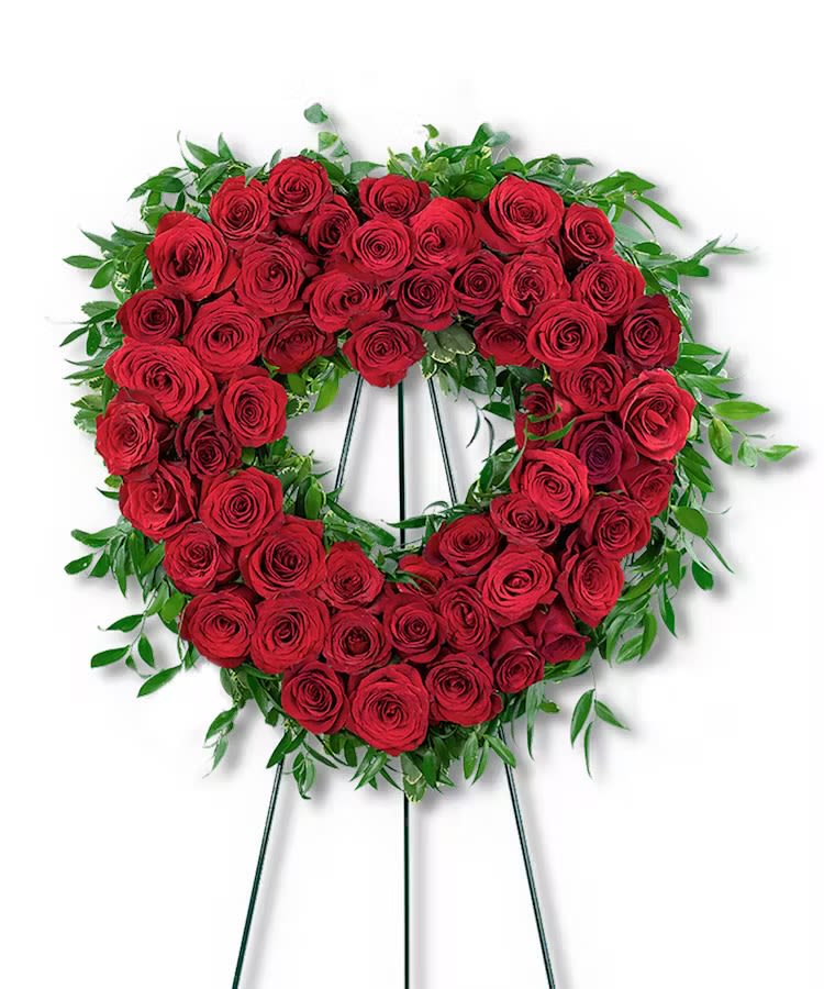Heart-shaped wreath of red roses on a standing easel