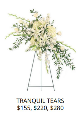 White floral standing spray on an easel