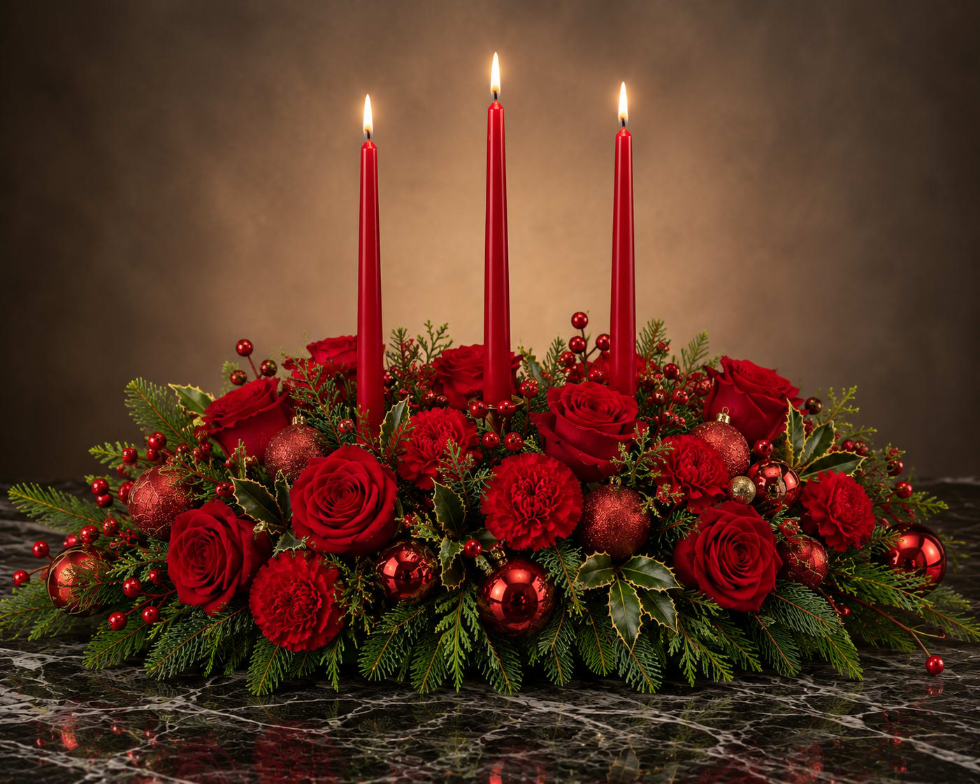 Holiday Ruby Glow - Deep, traditional holiday charm shines in this low, elongated holiday centerpiece-perfect for a Christmas table centerpiece or winter entertaining. Rich red roses and velvety red carnations form a dense, textured bed around glossy red ornaments and evergreen sprigs, while three tall red taper candles rising from the center create a formal, symmetrical focal point that draws the eye and warms the room.  Designed for seasonal celebrations, the arrangement's compact footprint makes it ideal for dining tables, buffets, or a mantel where guests can admire it without blocking sightlines. Colors are classic red and green with mixed accents from the ornaments; materials include fresh roses and carnations, evergreen foliage, glossy red ornaments, and three taper candles. The result is the kind of centerpiece that makes the person you're celebrating feel cherished and sets a festive, elegant tone for holiday gatherings.
