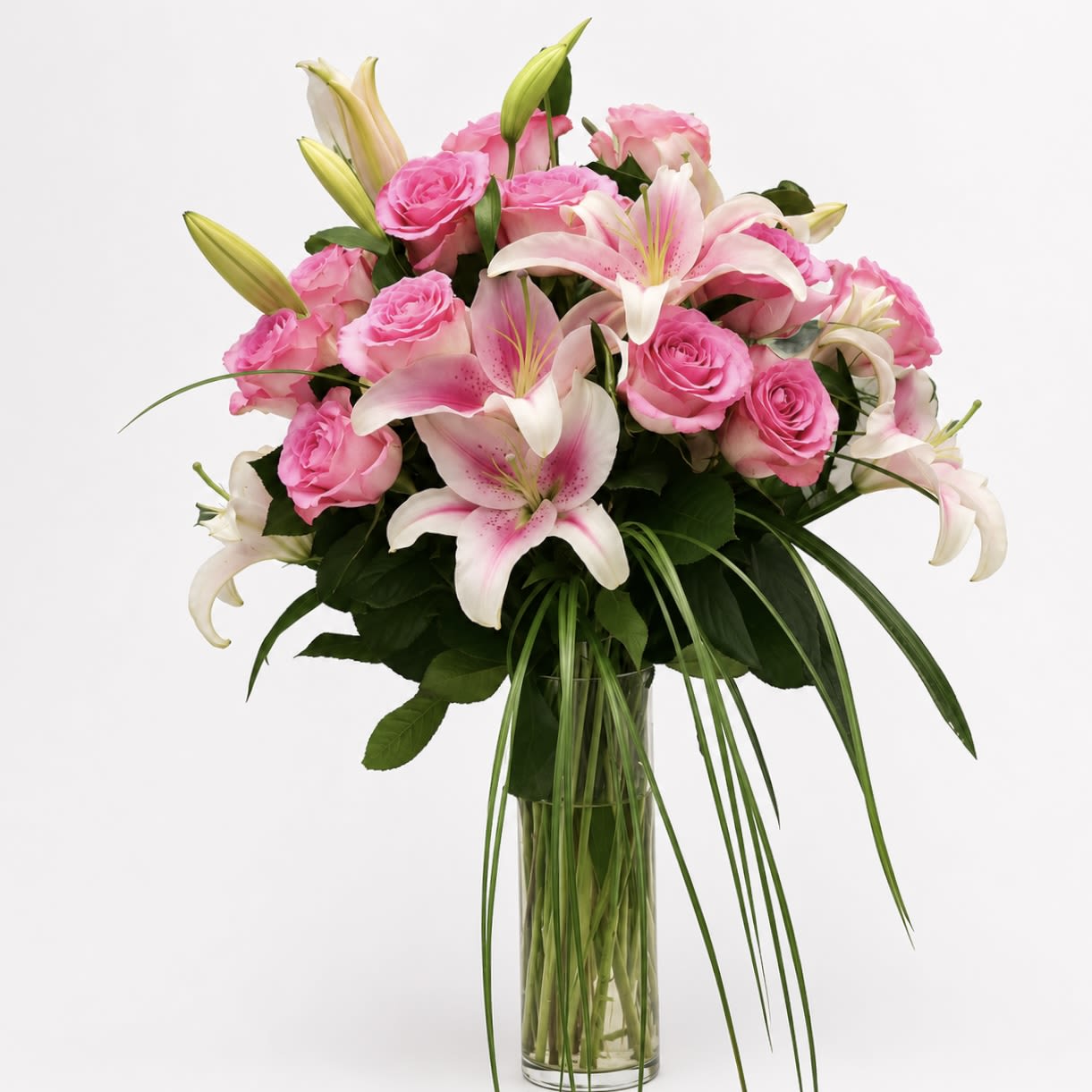 Pink Roses &amp; Lilies  - A timeless arrangement of one dozen premium pink roses paired with elegant pink lilies and lush greenery. This simple design blends classic beauty with soft sophistication—the perfect gesture of affection. 