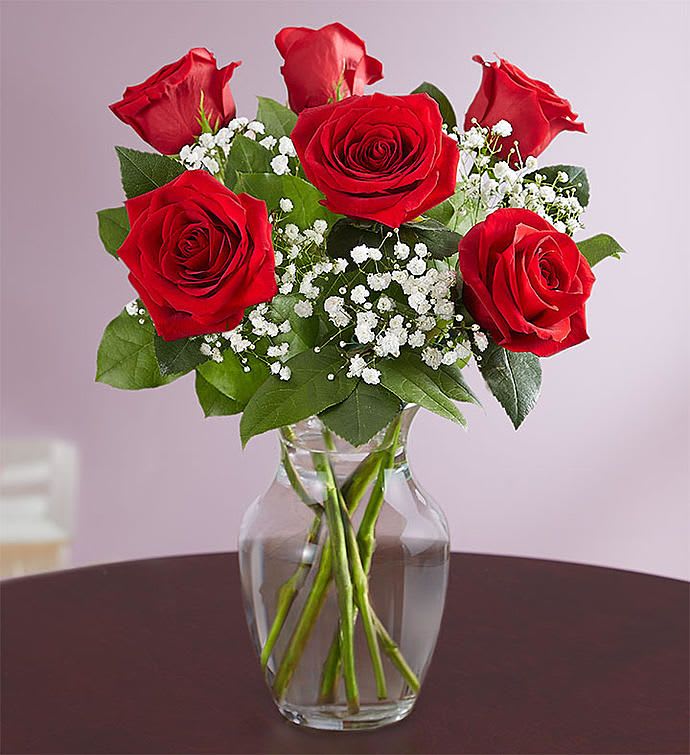 Love’s Embrace Half Dozen Red Roses - Send someone a passionate embrace with our classic gift of red roses. Beautifully arranged by our skilled florists with lush greenery inside an elegant glass vase, six radiant blooms are delivered right to the door to delight them for a birthday, anniversary or an everyday romantic surprise.