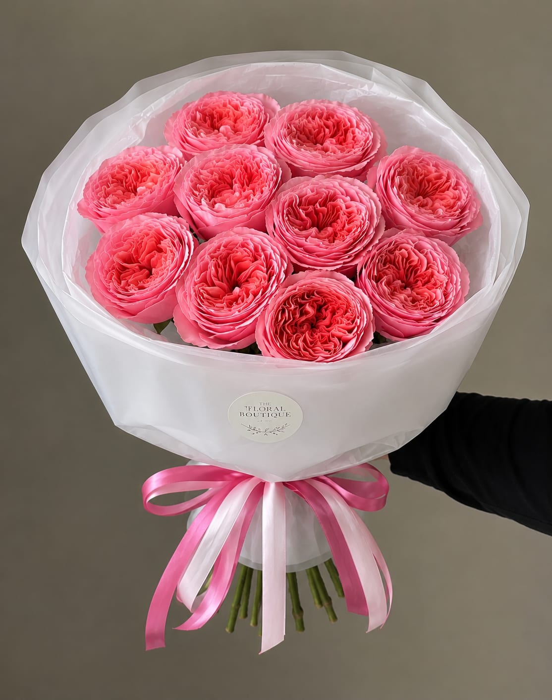 Garden Rose Bouquet - Elegant, timeless, and effortlessly romantic, our Garden Rose Bouquet features premium pink garden roses hand-selected for their lush, ruffled blooms and exceptional beauty. Each bouquet is expertly arranged and wrapped in our signature white luxury floral wrap, finished with soft satin ribbons for a sophisticated presentation.  Perfect for birthdays, anniversaries, congratulations, or simply letting someone know they’re loved, this bouquet makes a stunning statement with its full, garden-inspired look.  Details:  * Premium pink garden roses * Hand-tied by our designers * Signature luxury white wrapping * Finished with satin ribbon  Please note: As flowers are a natural product, bloom size and shades of pink may vary slightly based on seasonal availability while maintaining the bouquet’s overall style and quality.