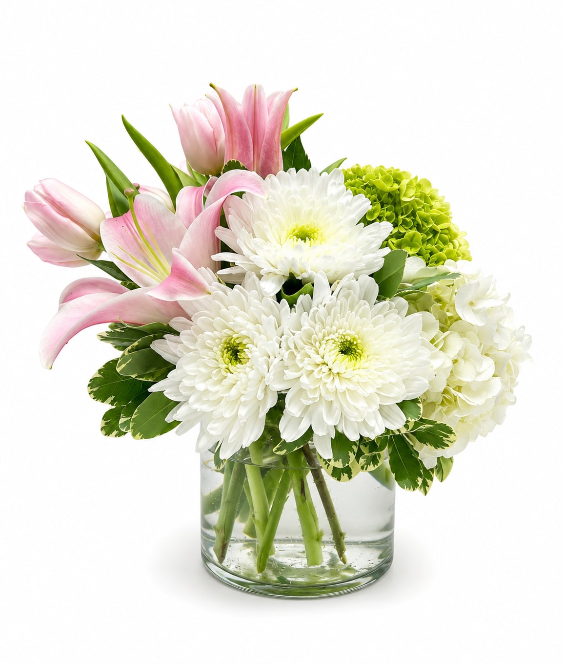 Blush &amp; Bloom - Blush &amp; Bloom is a graceful arrangement featuring soft pink lilies and tulips, crisp white chrysanthemums, lush white hydrangeas, and vibrant green accents. Designed in a clear glass vase, this elegant bouquet brings timeless beauty, freshness, and charm to any celebration or heartfelt occasion.