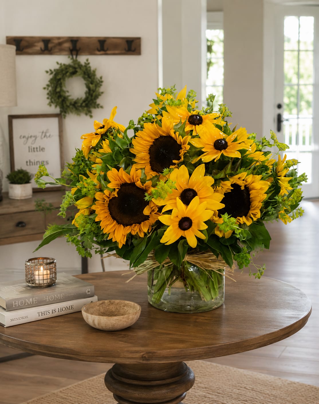 Sunflowers and Susans - Sunshine has a way of changing everything.  When you want to send happiness, encouragement, celebration, or a simple reminder that someone is loved, this is the arrangement that does the talking for you. Bursting with radiant sunflowers and cheerful black-eyed Susans, this luxury design instantly brightens a room and lifts the mood of everyone who sees it.  The bold golden blooms create an unmistakable feeling of warmth, optimism, and joy. Whether you’re celebrating a birthday, sending congratulations, welcoming someone home, wishing them well, saying thank you, or simply making someone’s day a little brighter, this arrangement delivers a powerful emotional impact the moment it arrives.  Designed to feel abundant, energetic, and full of life, this arrangement brings together the natural beauty of fresh flowers with a relaxed garden-inspired style that feels both elegant and approachable. The vibrant yellow blooms symbolize happiness, friendship, positivity, and hope, making this an exceptional choice for both celebrations and thoughtful everyday gifting.  Perfect for flower delivery in Greensburg, Indiana and surrounding communities, this luxury sunflower arrangement is a customer favorite for birthdays, get well gifts, thank you gifts, anniversaries, thinking of you occasions, summer celebrations, and just because moments.