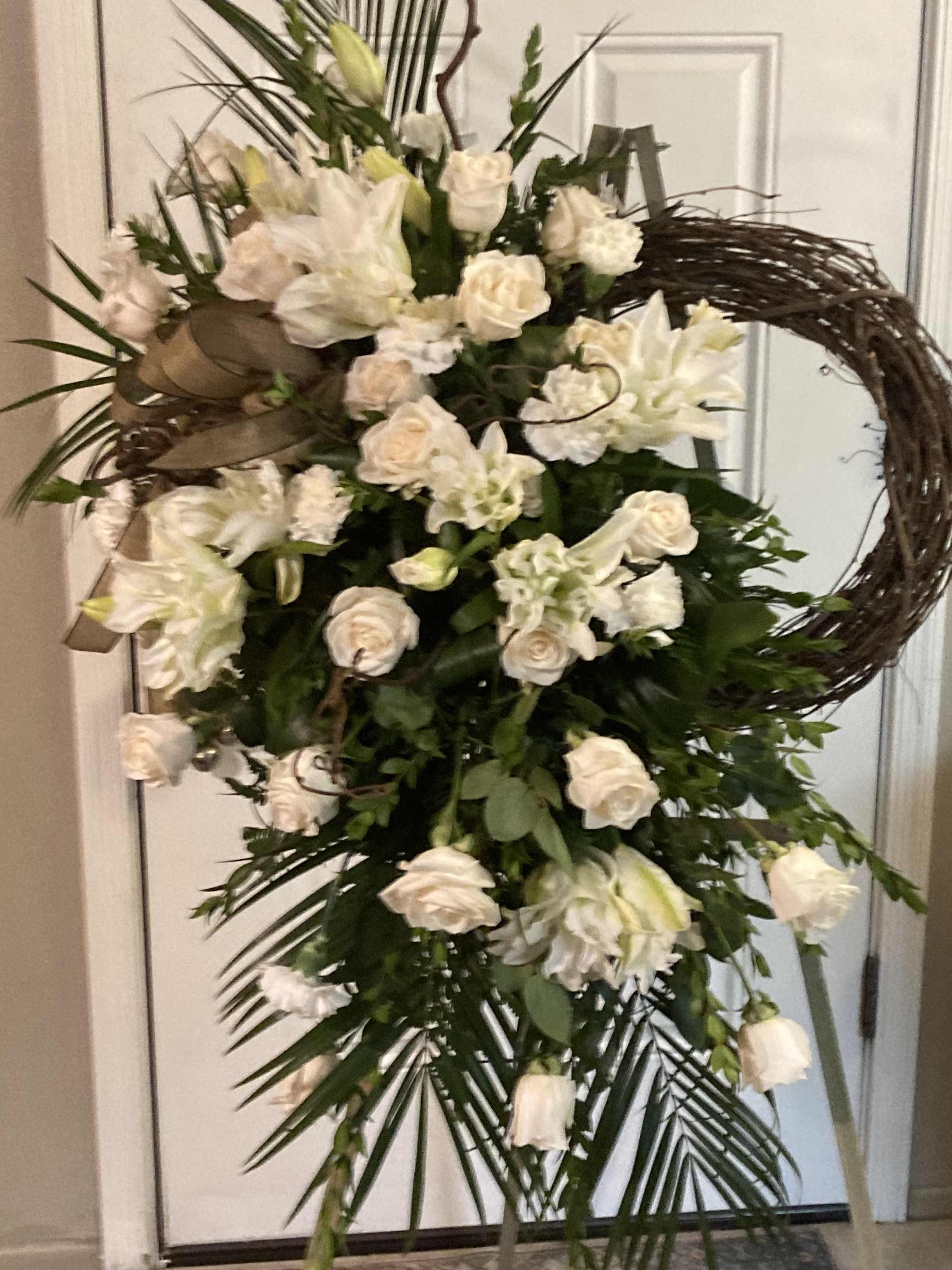 Tall white floral standing spray with roses and lilies