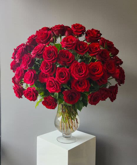 100 LOVE - 100 beautiful roses arranged in a custom vase.