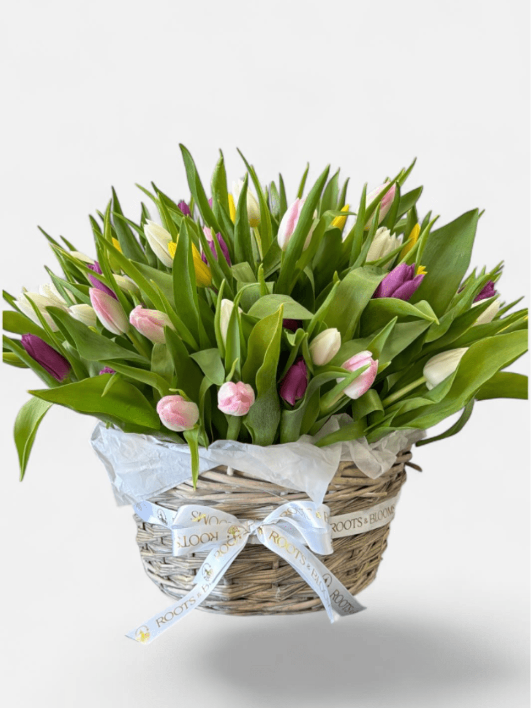 Spring Tulip Basket - A cheerful basket filled with colorful, seasonal, tulips and lush greenery, bringing a fresh touch of spring to any space.