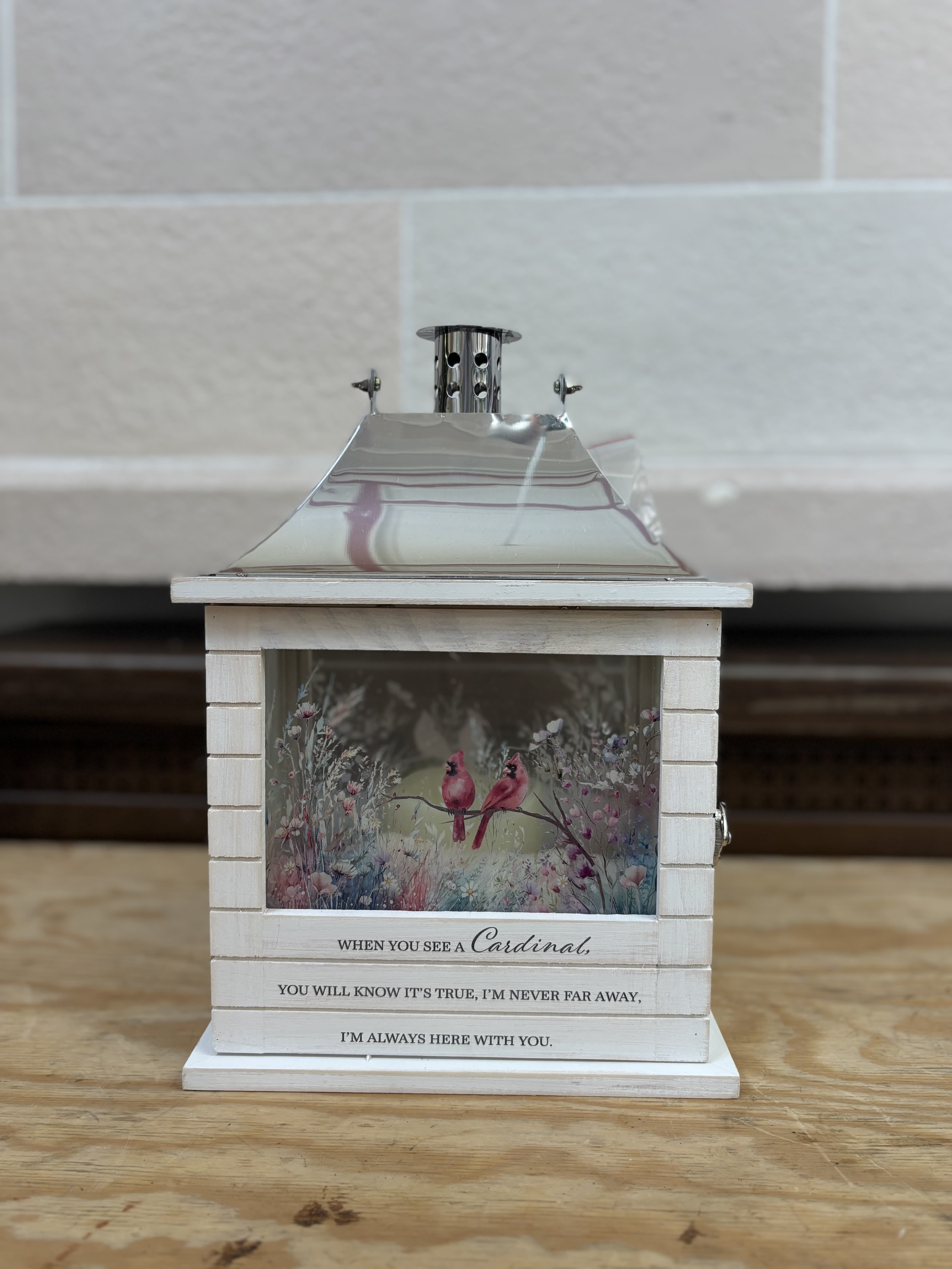 White lantern with cardinal artwork and memorial text