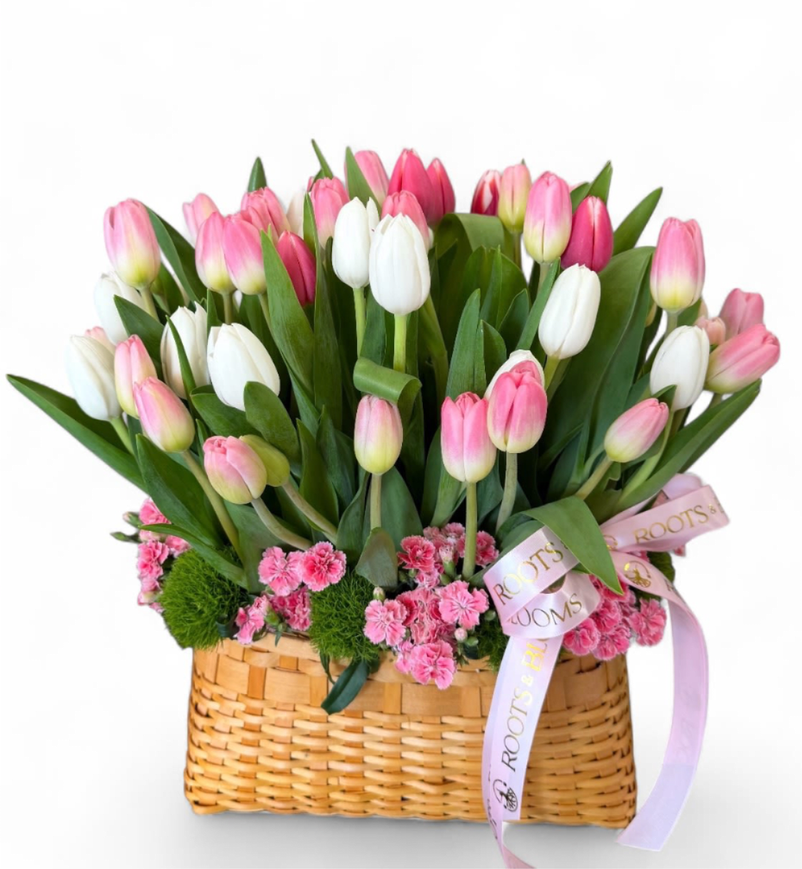 Blush Tulip Garden - A charming basket arrangement featuring a lush mix of pink and white tulips, accented with delicate pink blooms, and fresh greenery. Designed to feel like a blooming spring garden, this piece, bring softness, joy, and natural elegance to any space.
