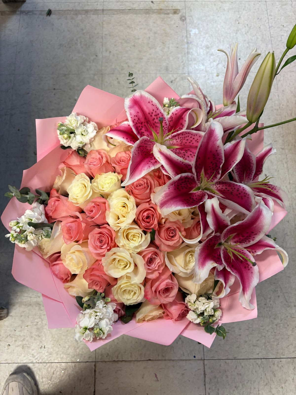 Lily delight - 50 pink and white roses  with blooming  lilies on top. 